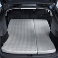 Rear view of a Tesla Model Y Juniper trunk area with the 3W custom split memory foam sleeping mattress fully extended for dual person car camping.