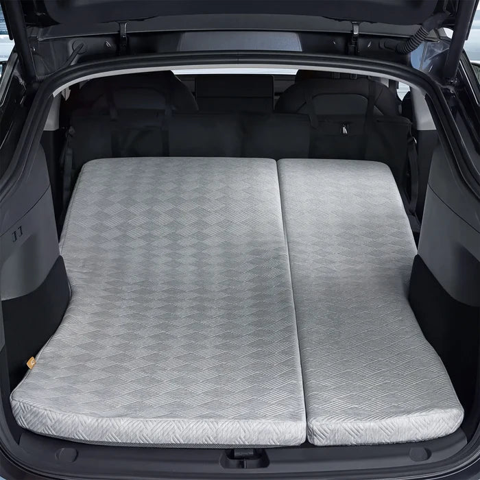 Rear view of a Tesla Model Y Juniper trunk area with the 3W custom split memory foam sleeping mattress fully extended for dual person car camping.