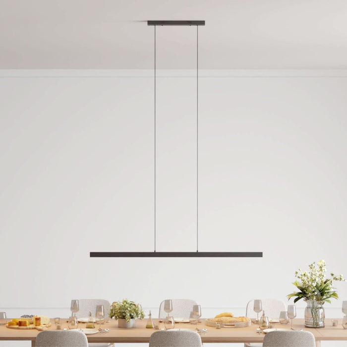 Slim black linear LED pendant above a dining table — Adjustable Linear Pendant — Touched Home