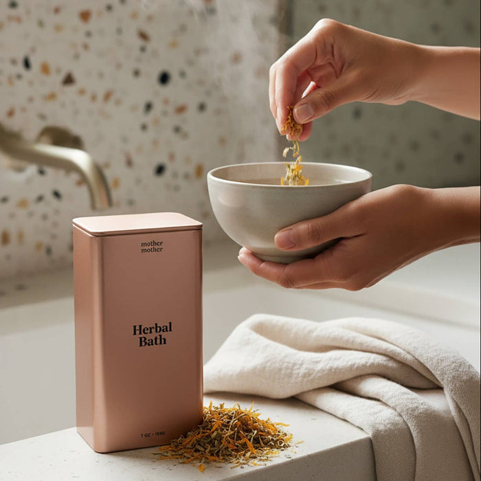 Woman preparing organic herbal sitz bath, pouring dried herbs into ceramic bowl with product packaging