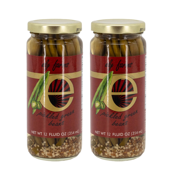 Two jars of Ely Farms pickled green beans on a white background