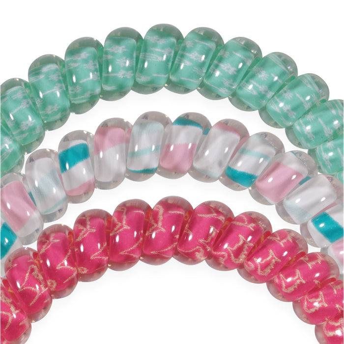 Three colorful TELETIES hair tie bracelets with striped and glitter patterns on black background