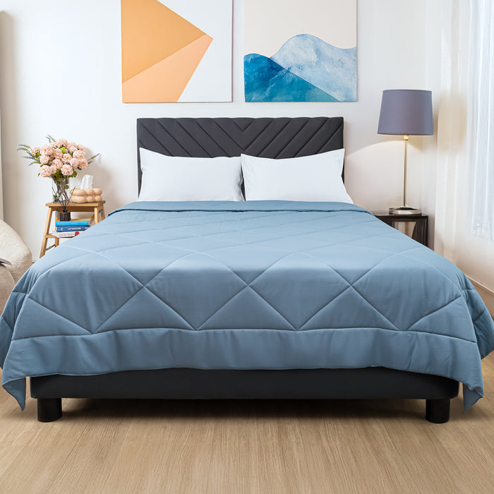 Wink Bed Linens Comforter in blue, shown in a room setting